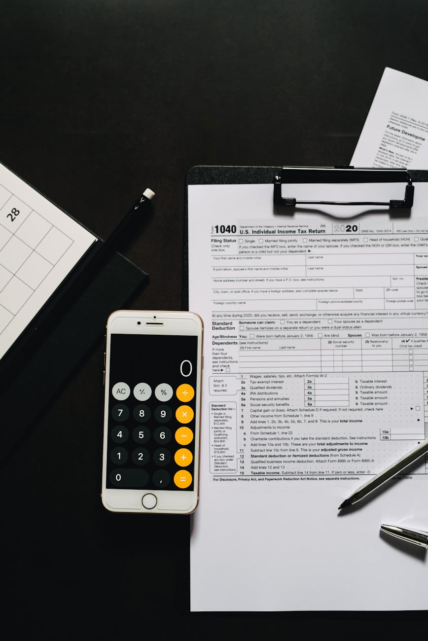 calculator smartphone on a clipboard with white paper