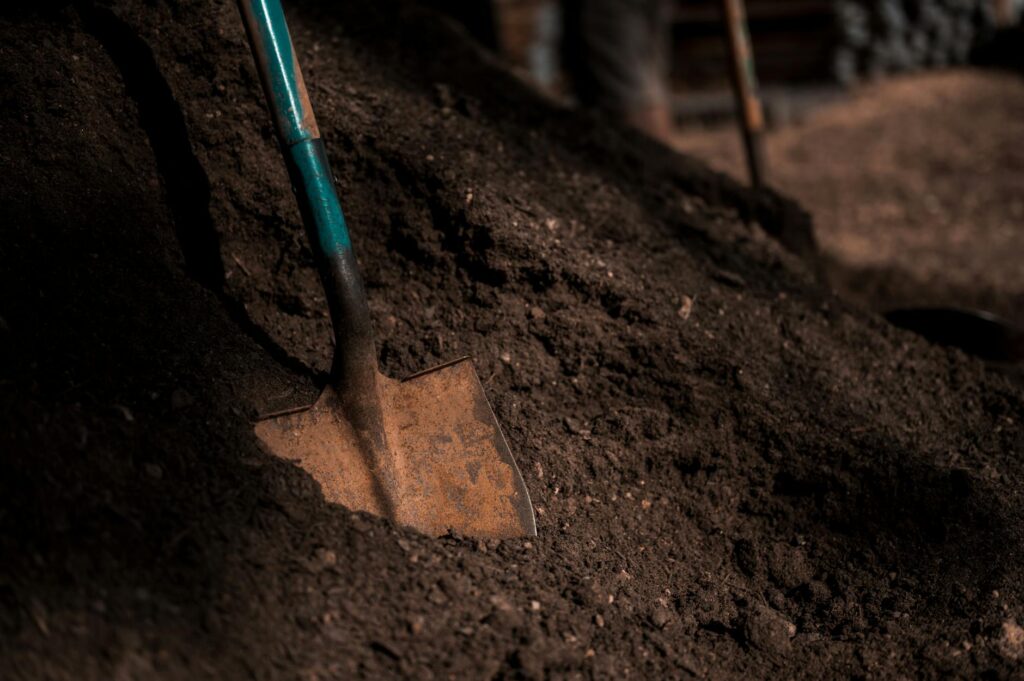 shovel on pile of soil