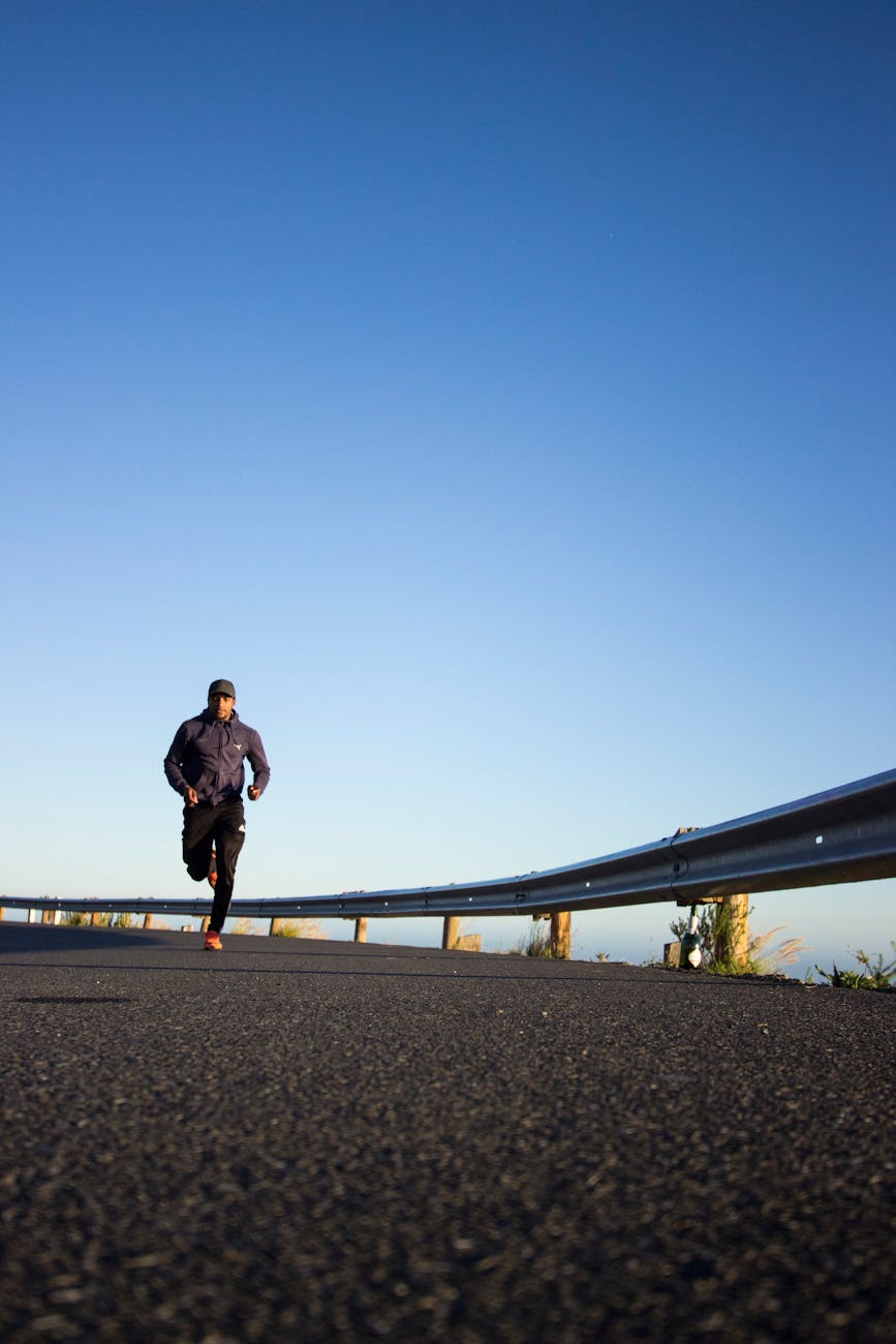 photo of man running during daytime