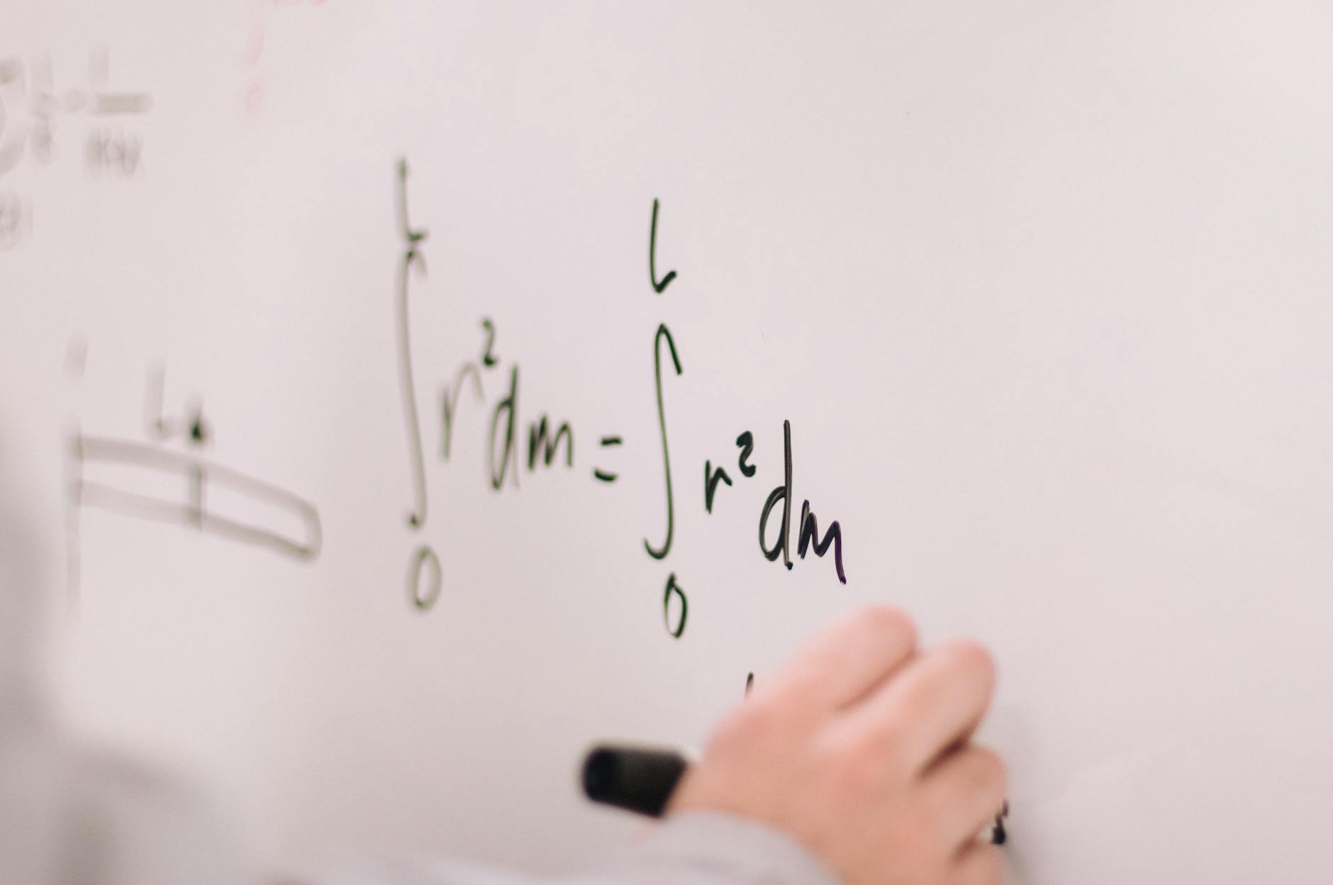 person writing on white board